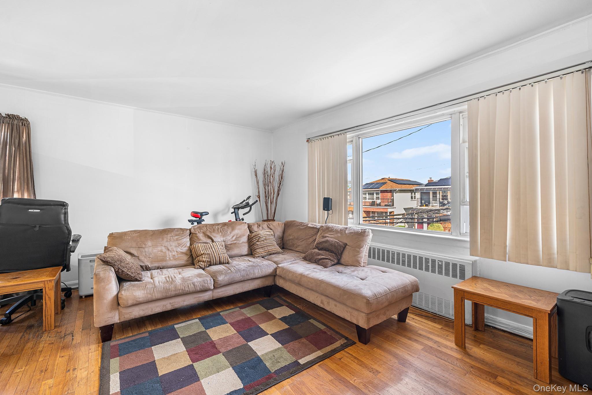 27-11 Deerfield Road Queens, NY 11691 - Photo 27 of 43 a living room with furniture and a window