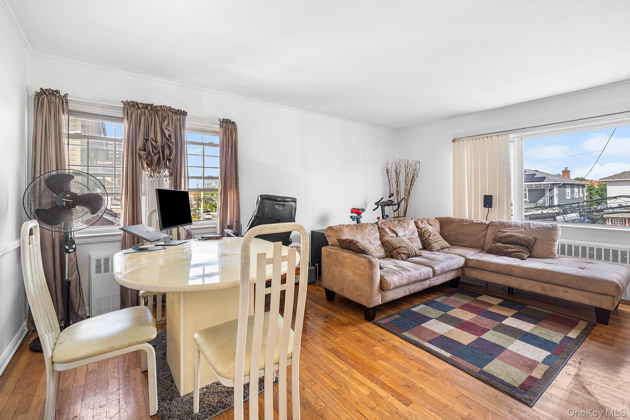 27-11 Deerfield Road Queens, NY 11691 - Photo 31 of 43 a living room with furniture a large window and a table