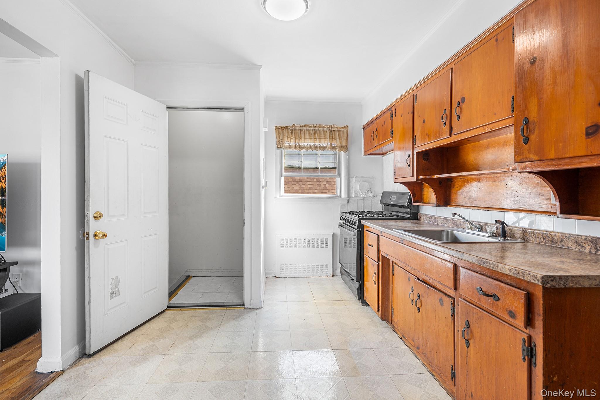 27-11 Deerfield Road Queens, NY 11691 - Photo 32 of 43 a kitchen with stainless steel appliances granite countertop a sink and cabinets