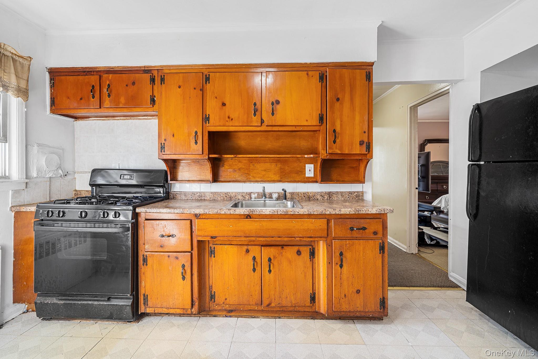 27-11 Deerfield Road Queens, NY 11691 - Photo 33 of 43 a kitchen with stainless steel appliances granite countertop a stove and a refrigerator