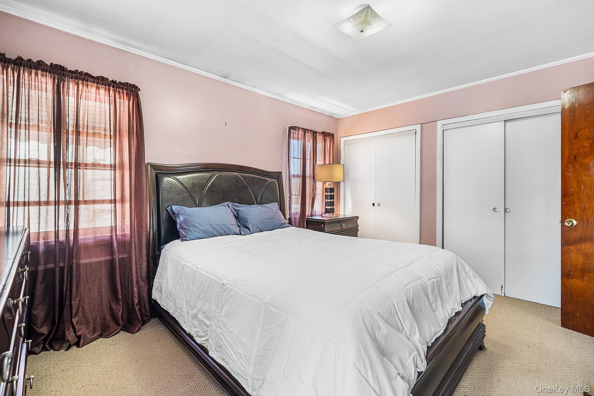 27-11 Deerfield Road Queens, NY 11691 - Photo 35 of 43 a bedroom with a bed and a window