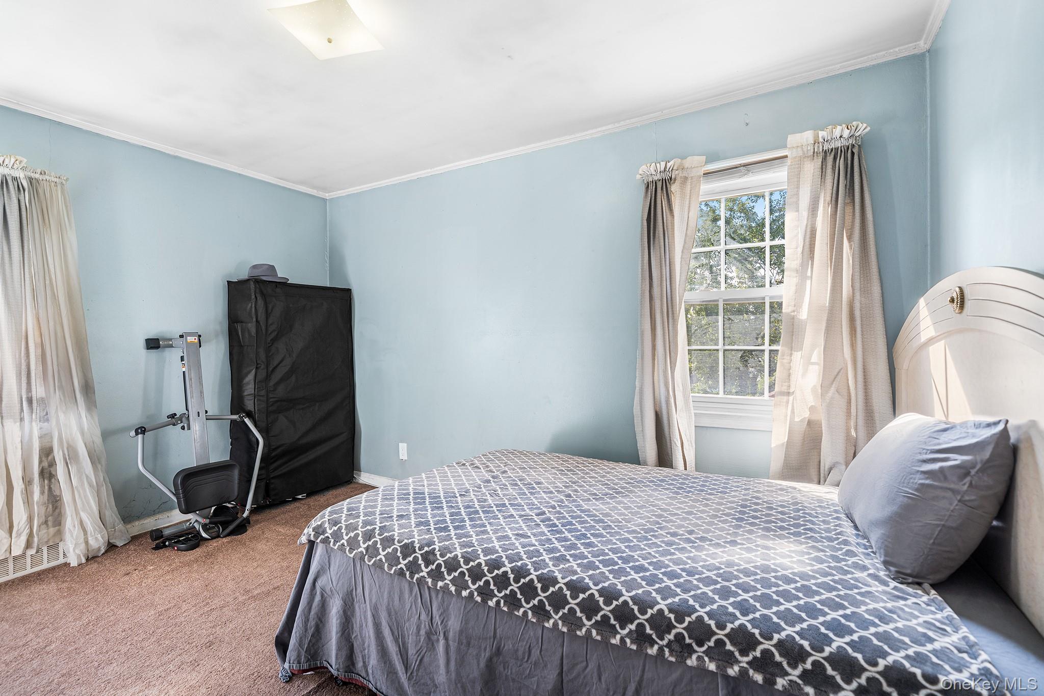 27-11 Deerfield Road Queens, NY 11691 - Photo 36 of 43 a bedroom with a bed and wooden floor