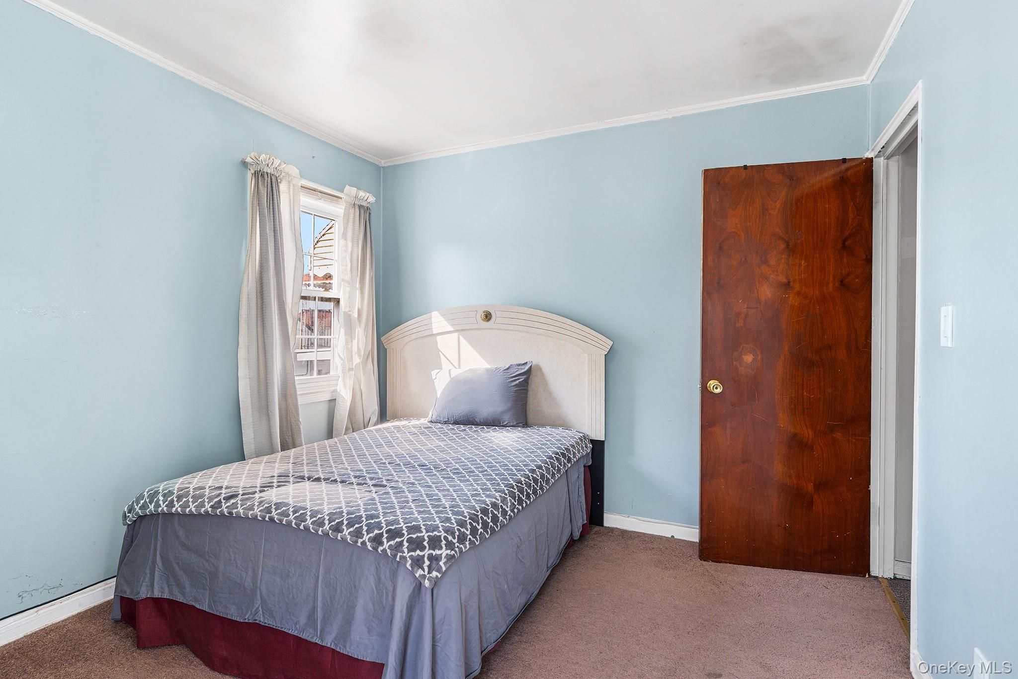 27-11 Deerfield Road Queens, NY 11691 - Photo 37 of 43 a bedroom with a bed and a window