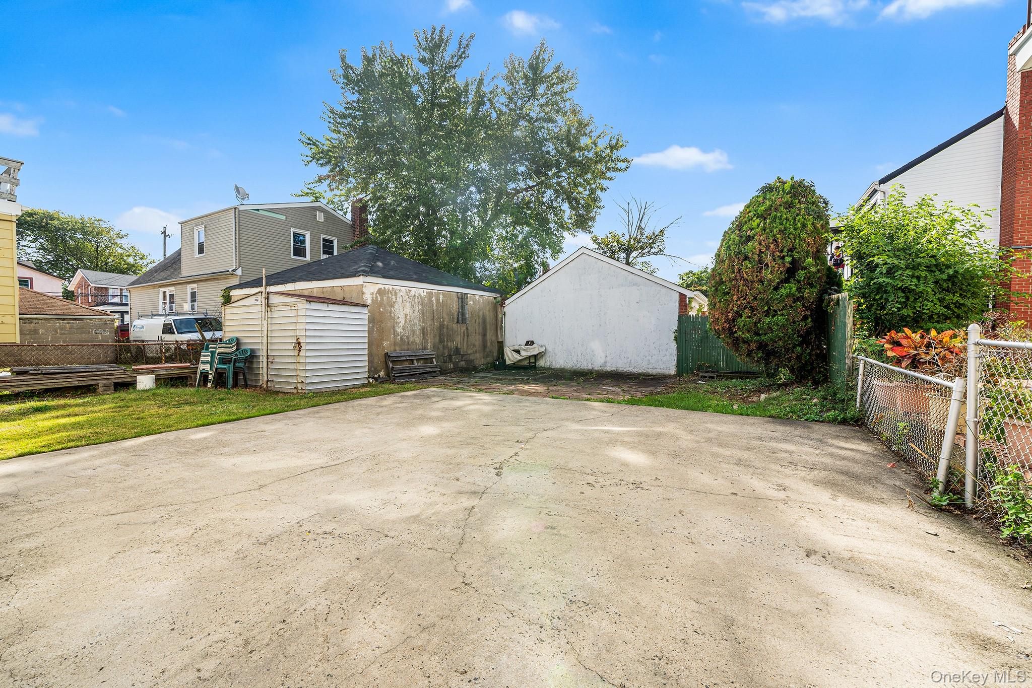 27-11 Deerfield Road Queens, NY 11691 - Photo 39 of 43 a view of a house with backyard and trees
