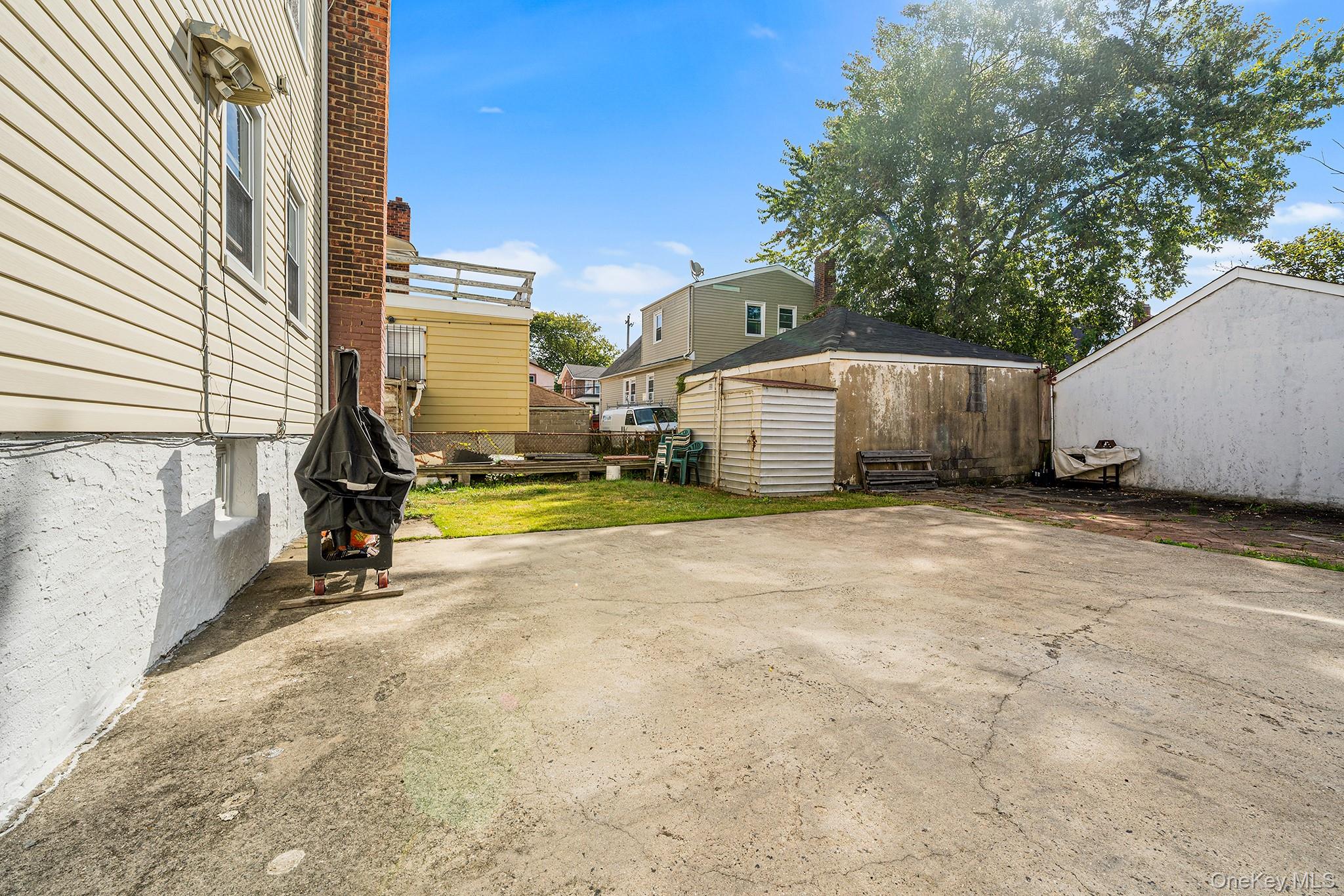 27-11 Deerfield Road Queens, NY 11691 - Photo 40 of 43 a view of a house with backyard and sitting area