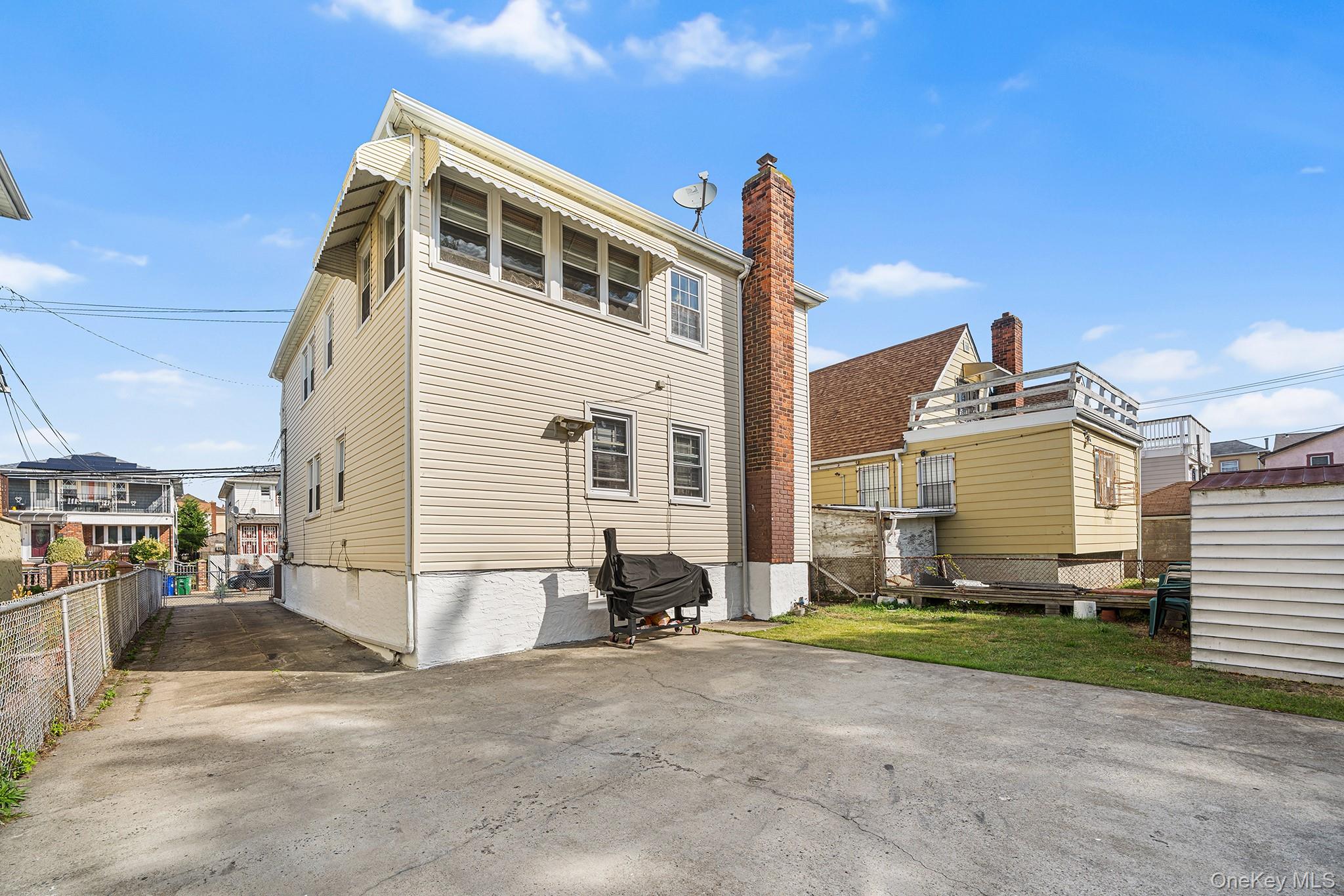 27-11 Deerfield Road Queens, NY 11691 - Photo 41 of 43 a front view of a house with a yard