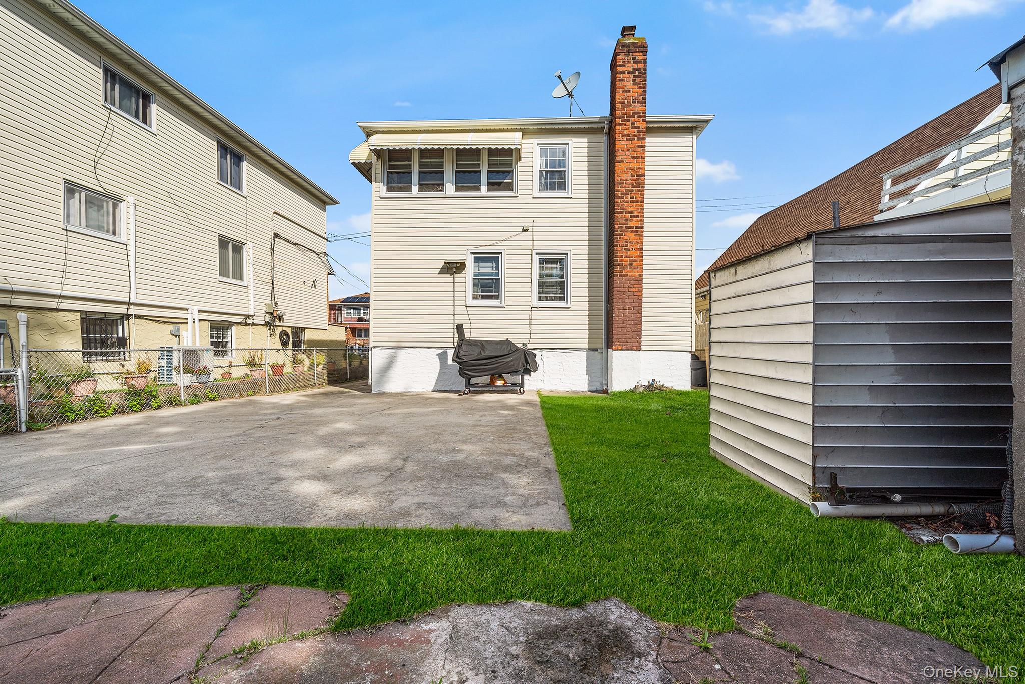 27-11 Deerfield Road Queens, NY 11691 - Photo 43 of 43 a front view of a house with a yard