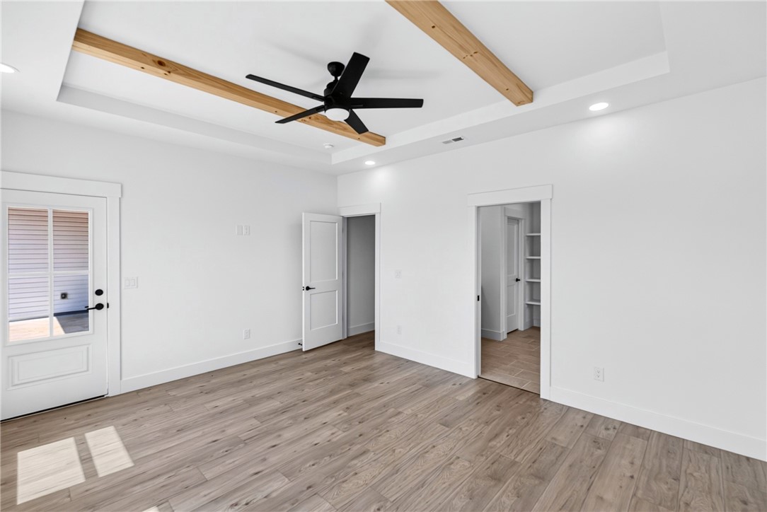 416 Blume Road Anderson, SC 29625 - Photo 20 of 29 A well-lit bedroom features a unique tray ceiling with exposed wooden beams and recessed lighting.