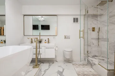 a bathroom with a sink a mirror and a shower
