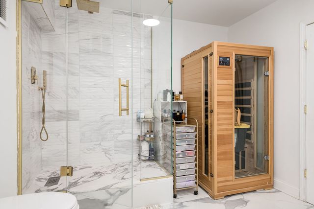 a view of a hallway with furniture and wooden floor