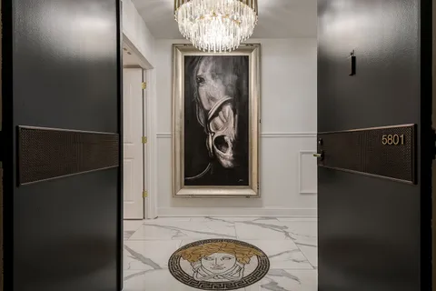 a kitchen with furniture a chandelier and a stove