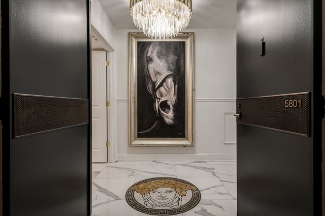 a kitchen with furniture a chandelier and a stove