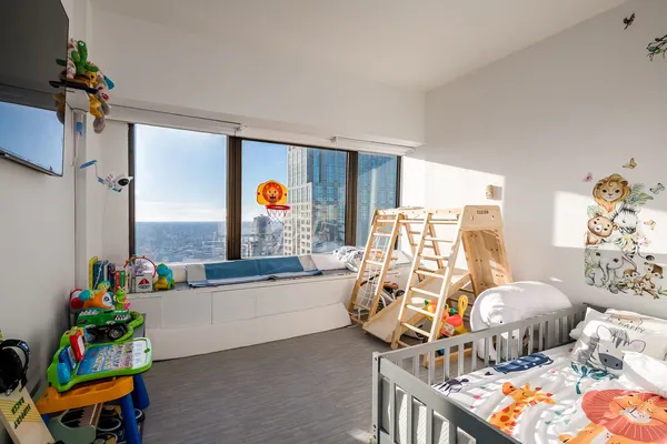 a bedroom with furniture and a large window