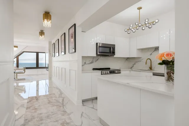 a kitchen with stainless steel appliances granite countertop a sink stove and microwave