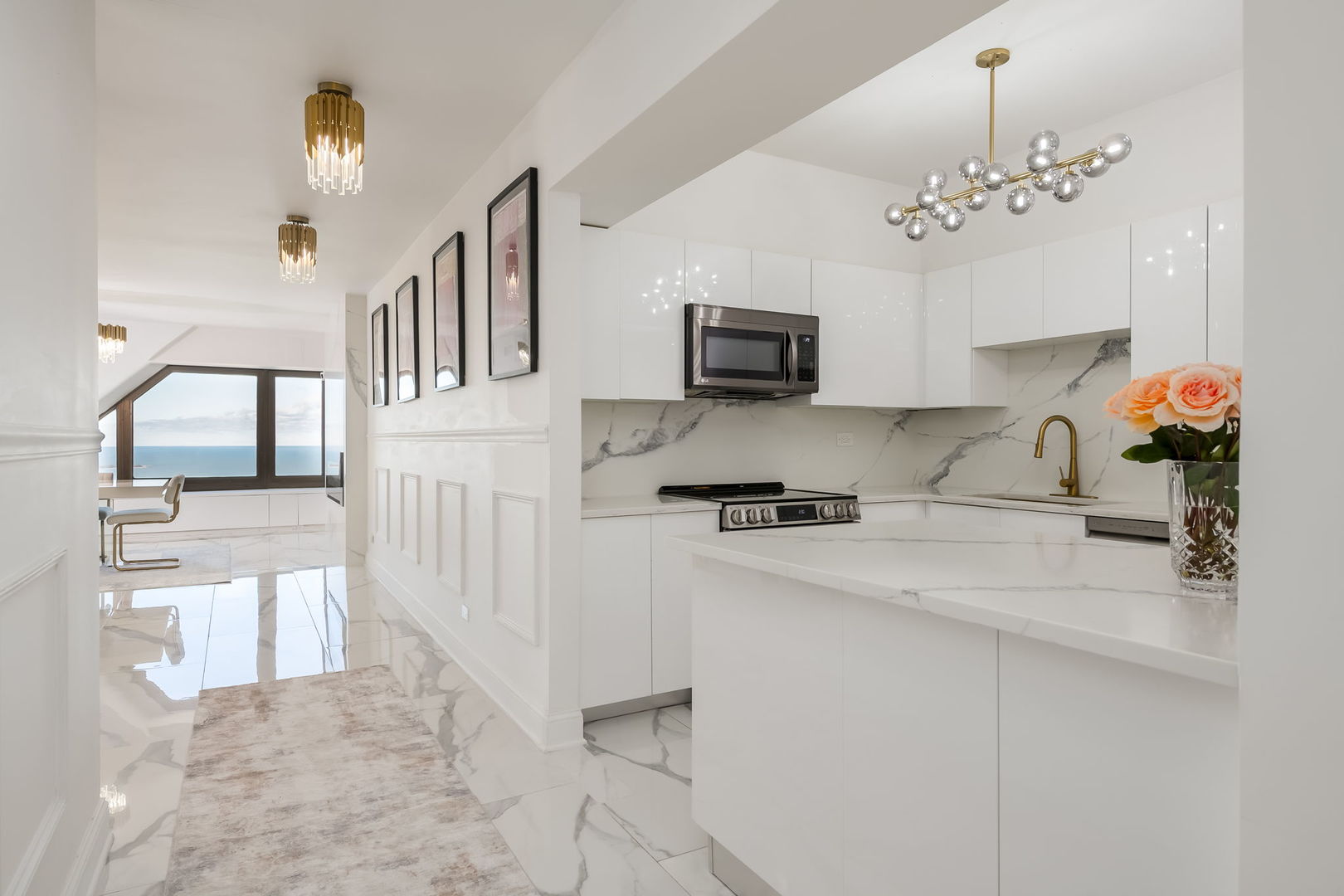 175 East Delaware Place, Unit 580102 Chicago, IL 60611 - Photo 3 of 33 a kitchen with furniture a chandelier and a stove