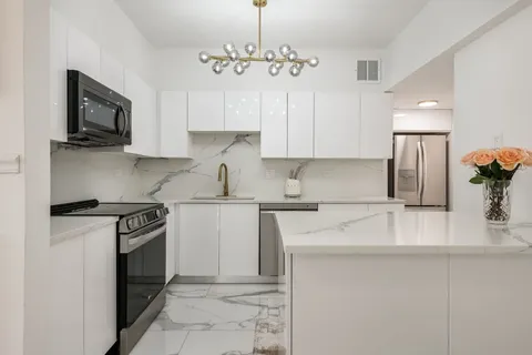 a kitchen with a sink and cabinets