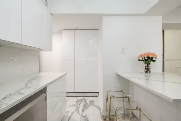 a kitchen with stainless steel appliances a stove a sink cabinets and a microwave