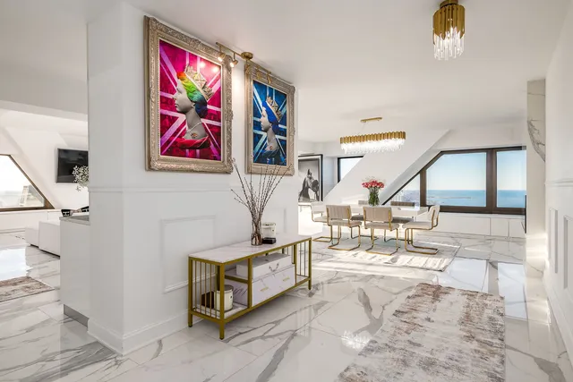 a view of a livingroom with furniture and floor to ceiling window