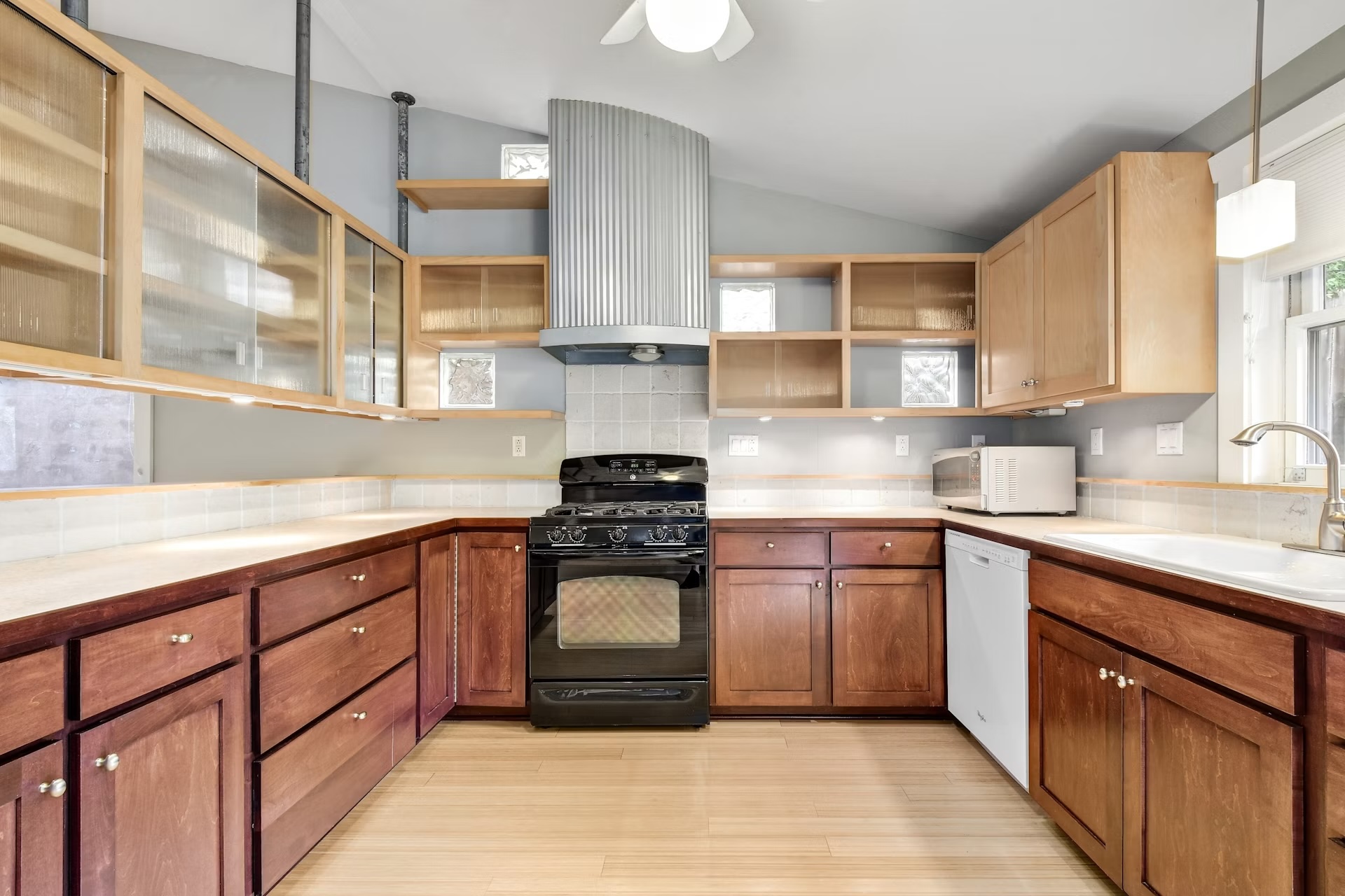 2117 A Rabb Road Austin, TX 78704 - Photo 11 of 21 Ample wooden cabinetry and vaulted ceilings define this functional kitchen.