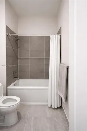 a bathroom with a toilet and a bathtub