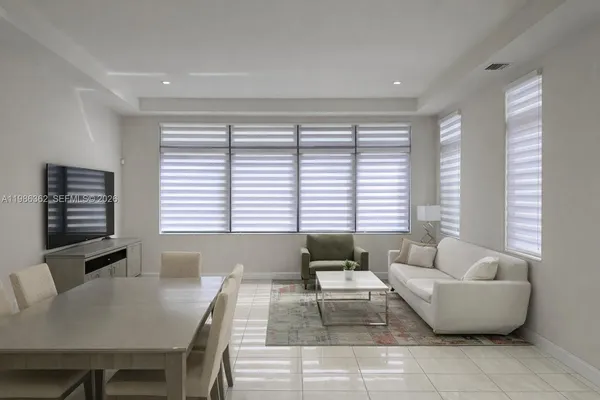 a living room with furniture and large windows