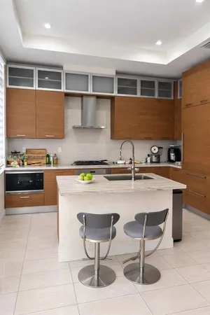 a kitchen with stainless steel appliances granite countertop a sink and a counter space