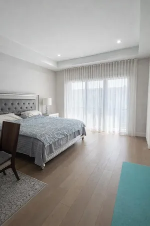 a bedroom with a bed and a chair