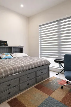 a bedroom with a bed and with furniture