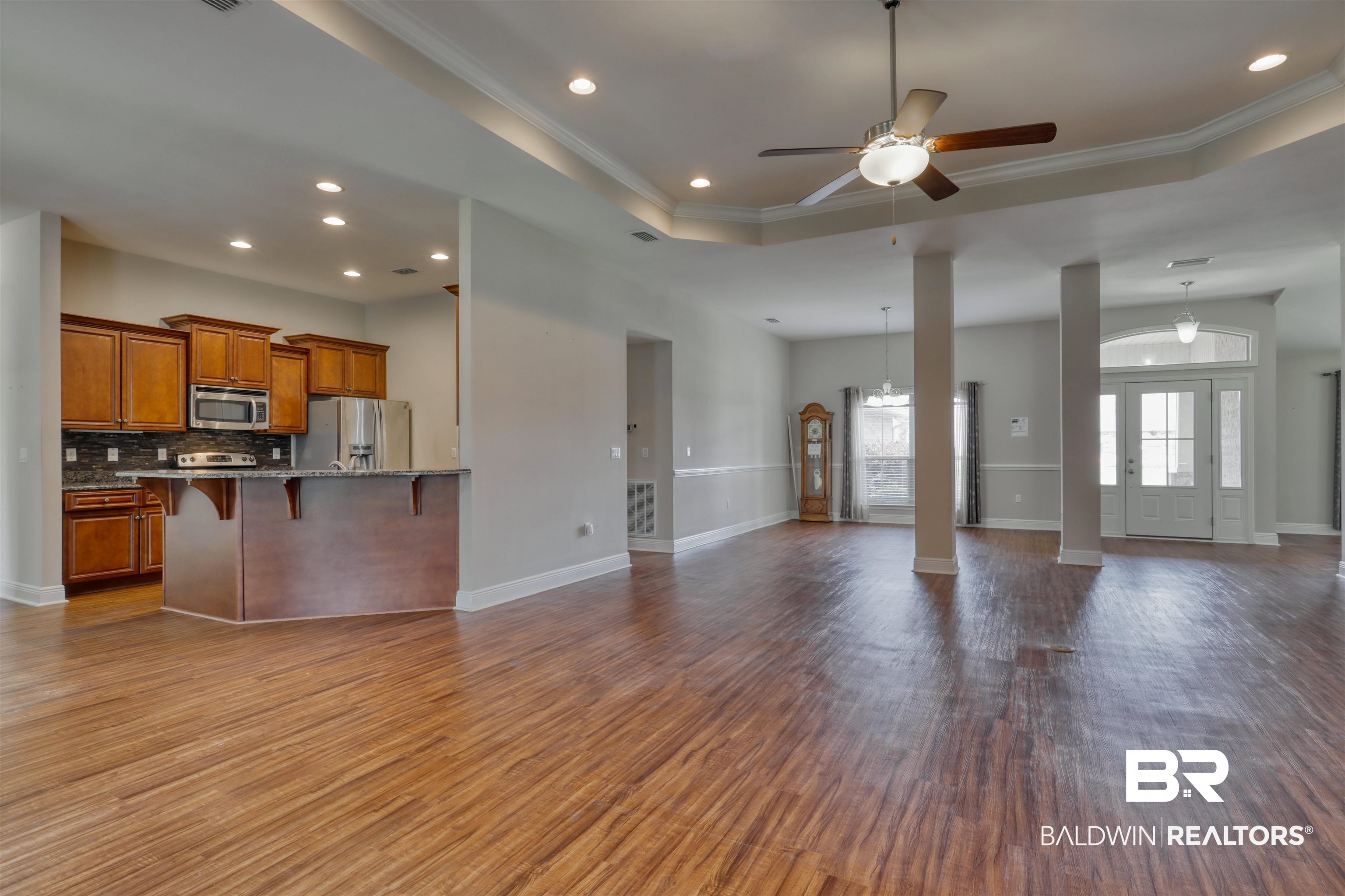 14794 Troon Drive Foley, AL 36535 - Photo 8 of 33 Unfurnished living room with dark wood-type flooring, recessed lighting, and ornamental molding