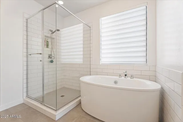 a white bath tub sitting next to a shower