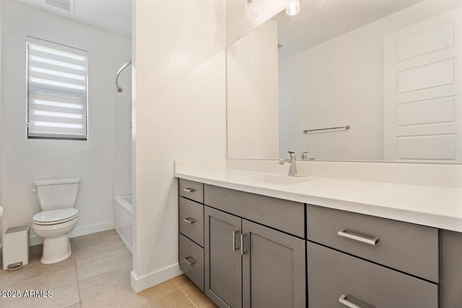 816 East Monte Way Phoenix, AZ 85042 - Photo 26 of 35 a bathroom with a sink a toilet and a mirror