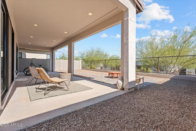 a backyard of a house with table and chairs