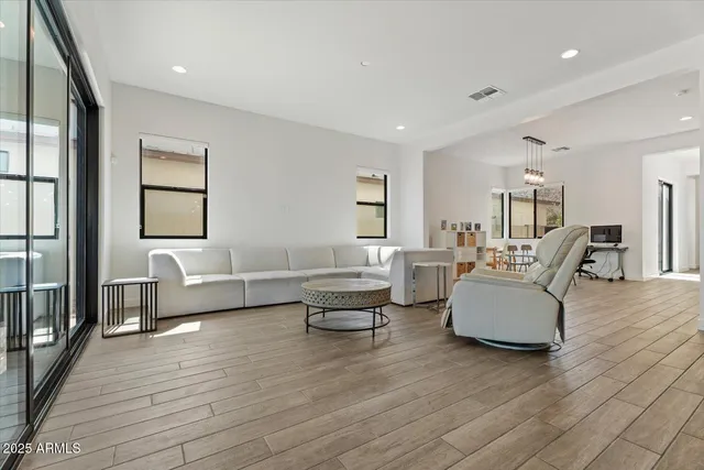 a living room with furniture and a wooden floor