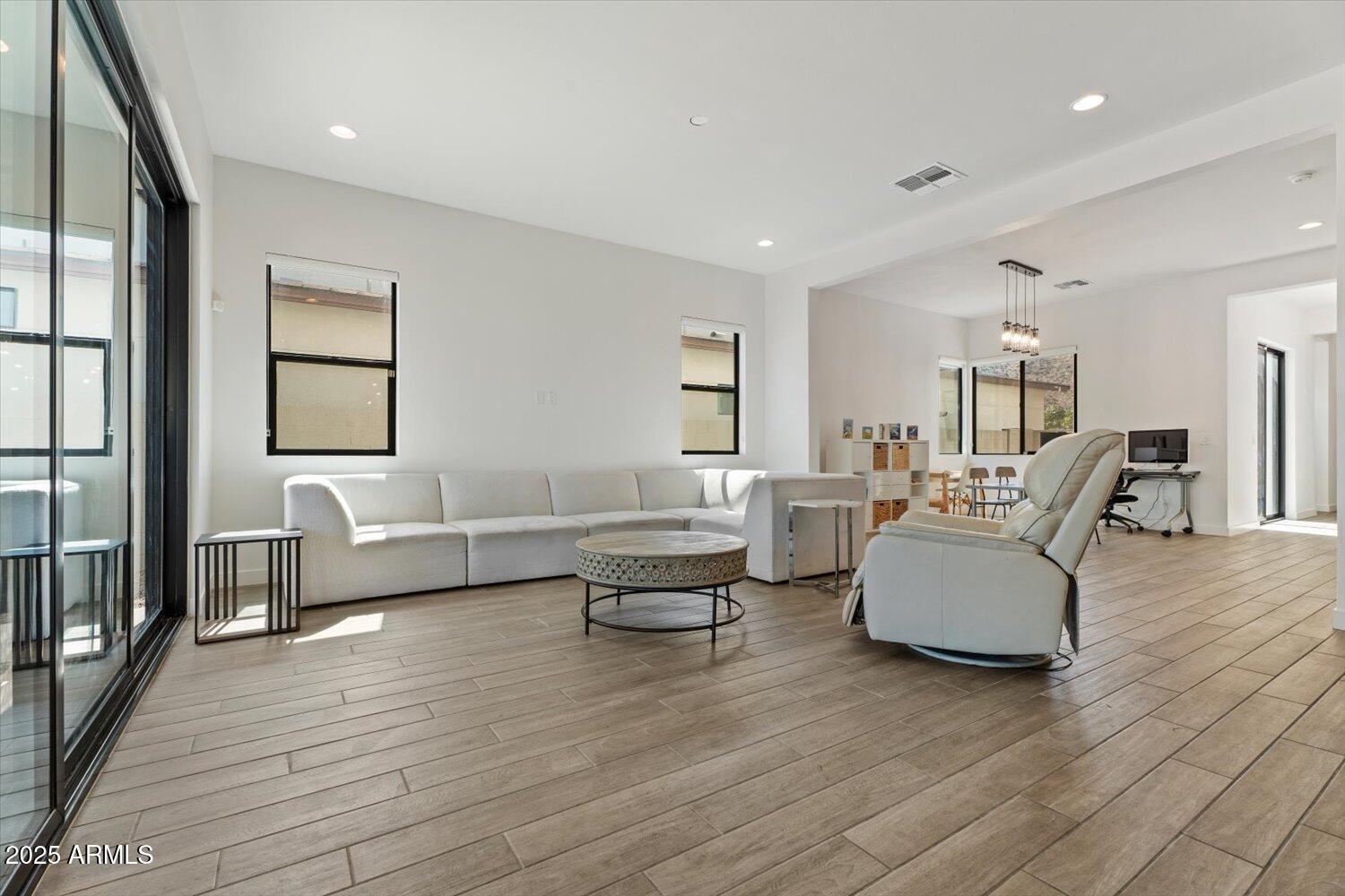 816 East Monte Way Phoenix, AZ 85042 - Photo 4 of 35 a living room with furniture and a wooden floor