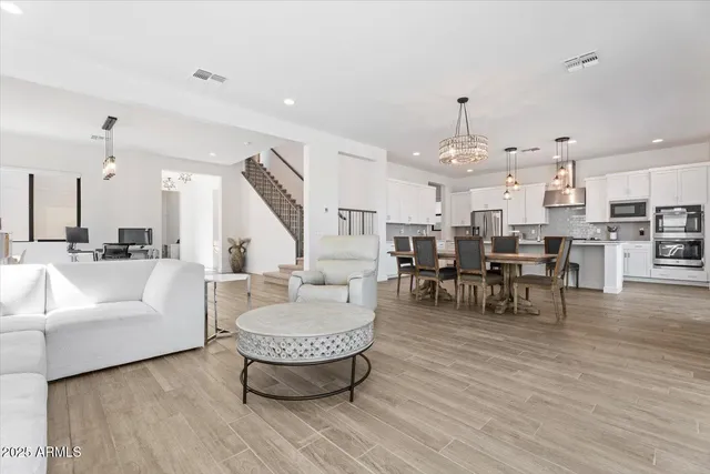 a living room with lots of furniture and kitchen view