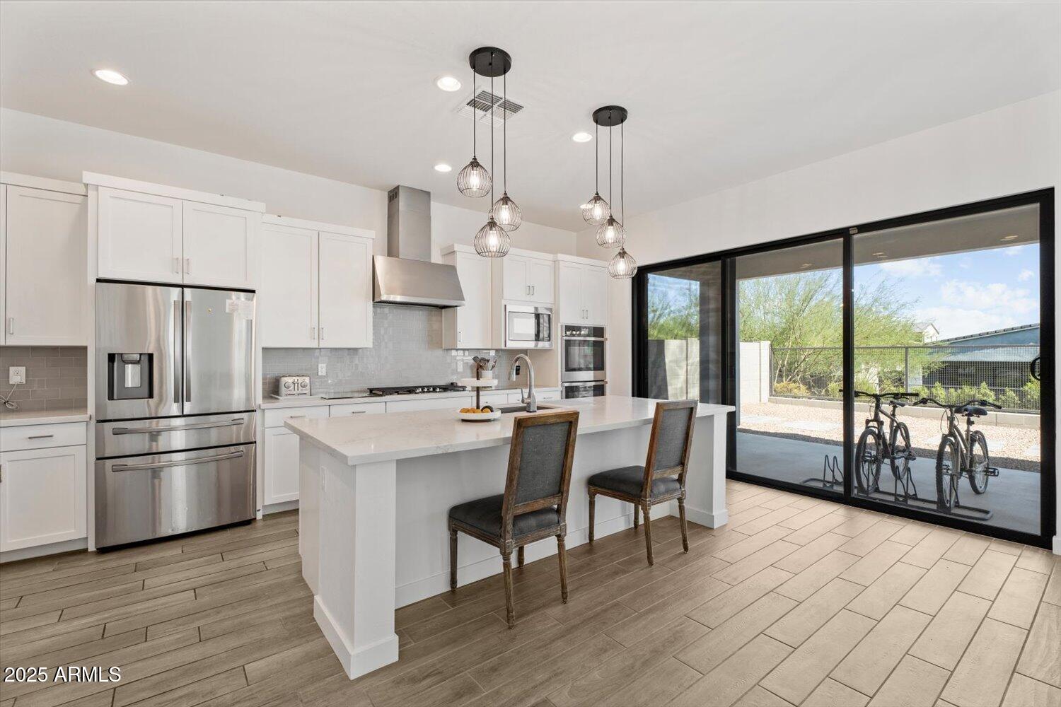 816 East Monte Way Phoenix, AZ 85042 - Photo 7 of 35 a kitchen with kitchen island a large counter top space and stainless steel appliances