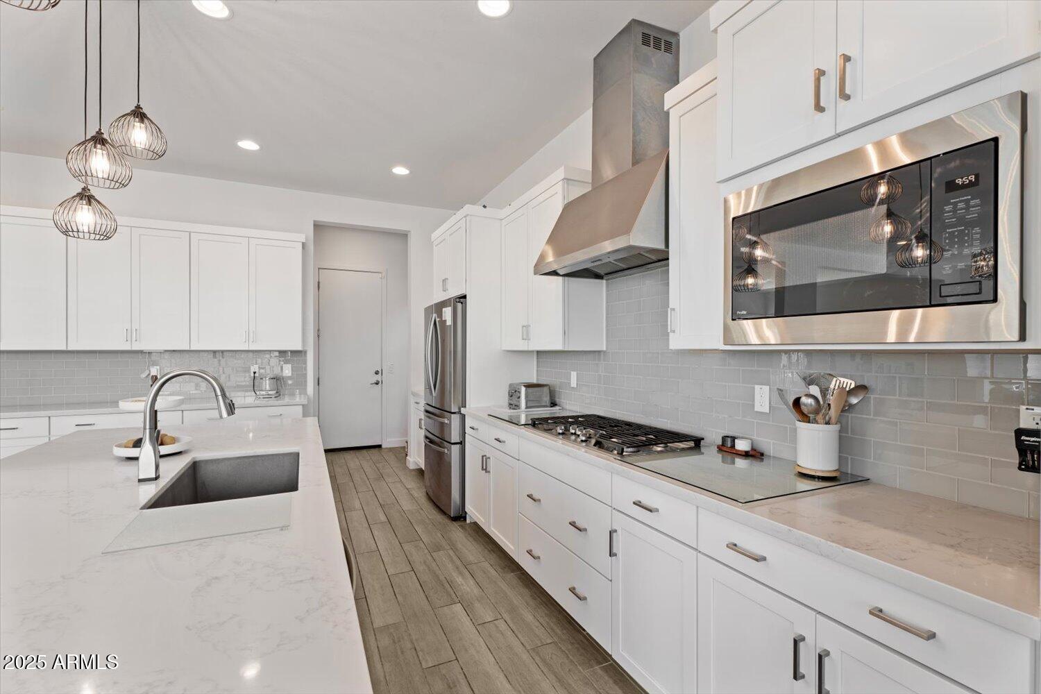 816 East Monte Way Phoenix, AZ 85042 - Photo 9 of 35 a kitchen with stainless steel appliances a sink a stove a microwave cabinets and a counter top space