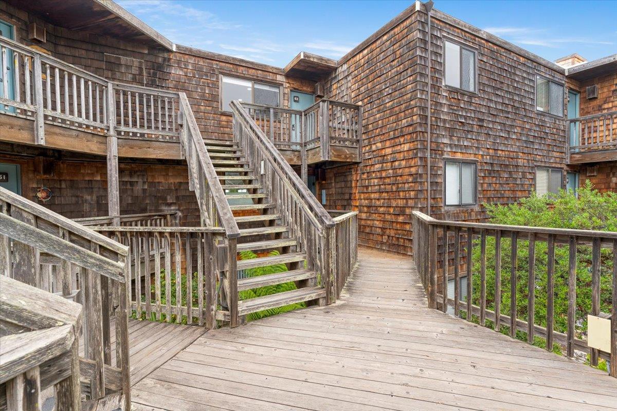 101 Shell Road, Unit 62 Watsonville, CA 95076 - Photo 2 of 38 a view of a brick house with wooden floor and fence