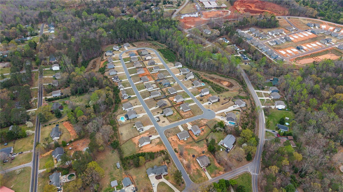 114 Sunny Pt Loop Central, SC 29630 - Photo 21 of 25 Aerial view shows a burgeoning residential community nestled within a verdant, tree-lined landscape.