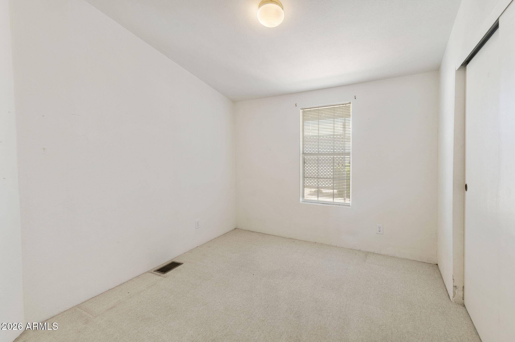 3700 South Tomahawk Road, Unit 73 Apache Junction, AZ 85119 - Photo 30 of 49 an empty room with a window