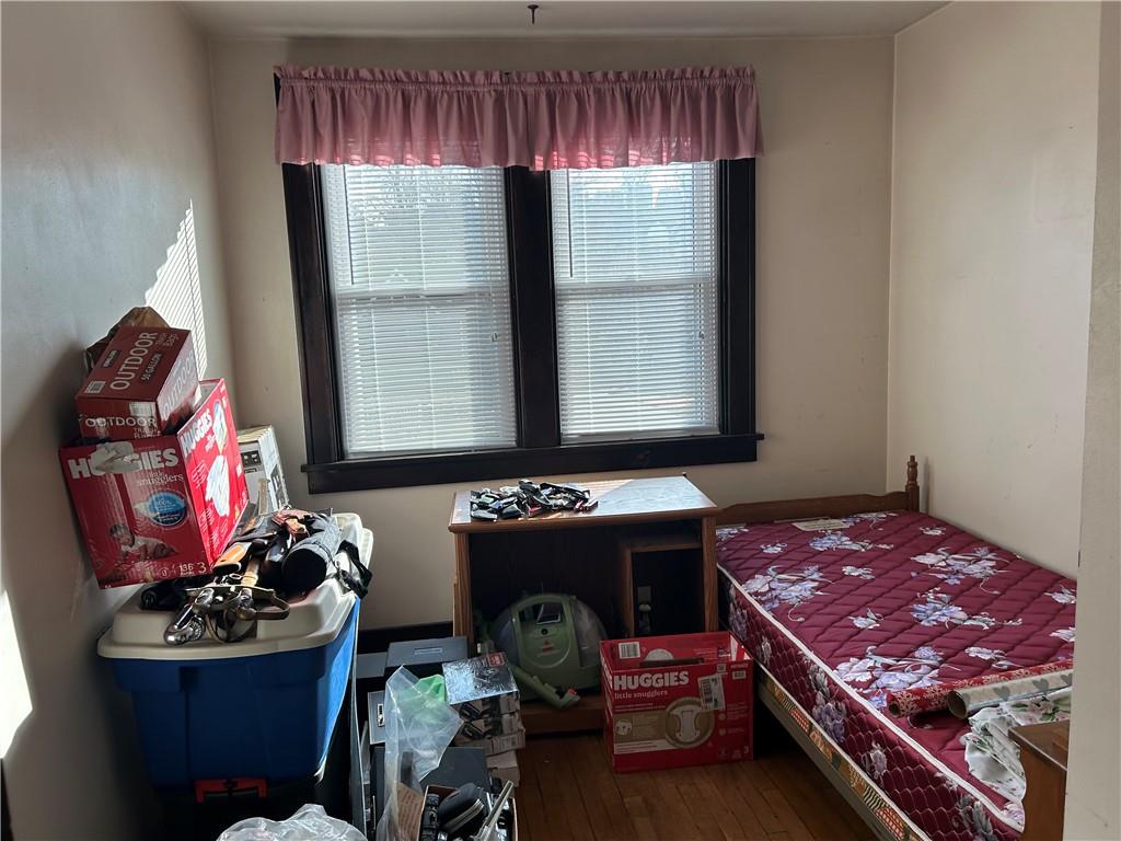 301 Meredith Street Pittsburgh, PA 15210 - Photo 11 of 30 a bed room with a bed and a chair