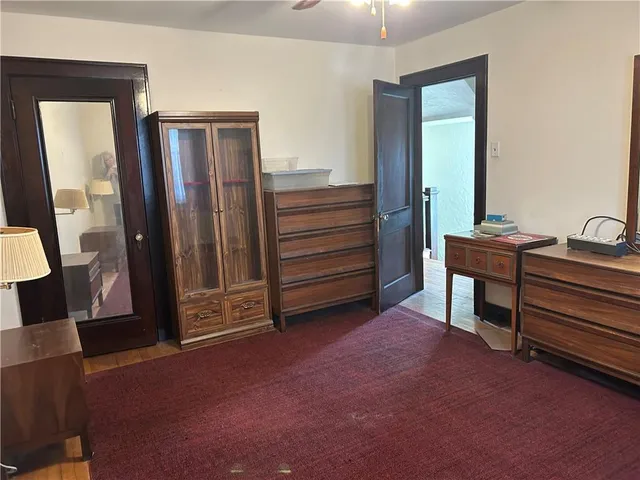 a room with a dresser and mirror