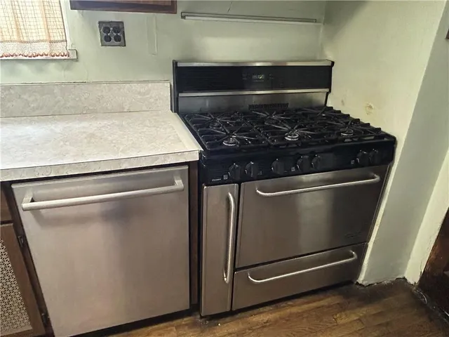 a metallic refrigerator freezer sitting in a kitchen