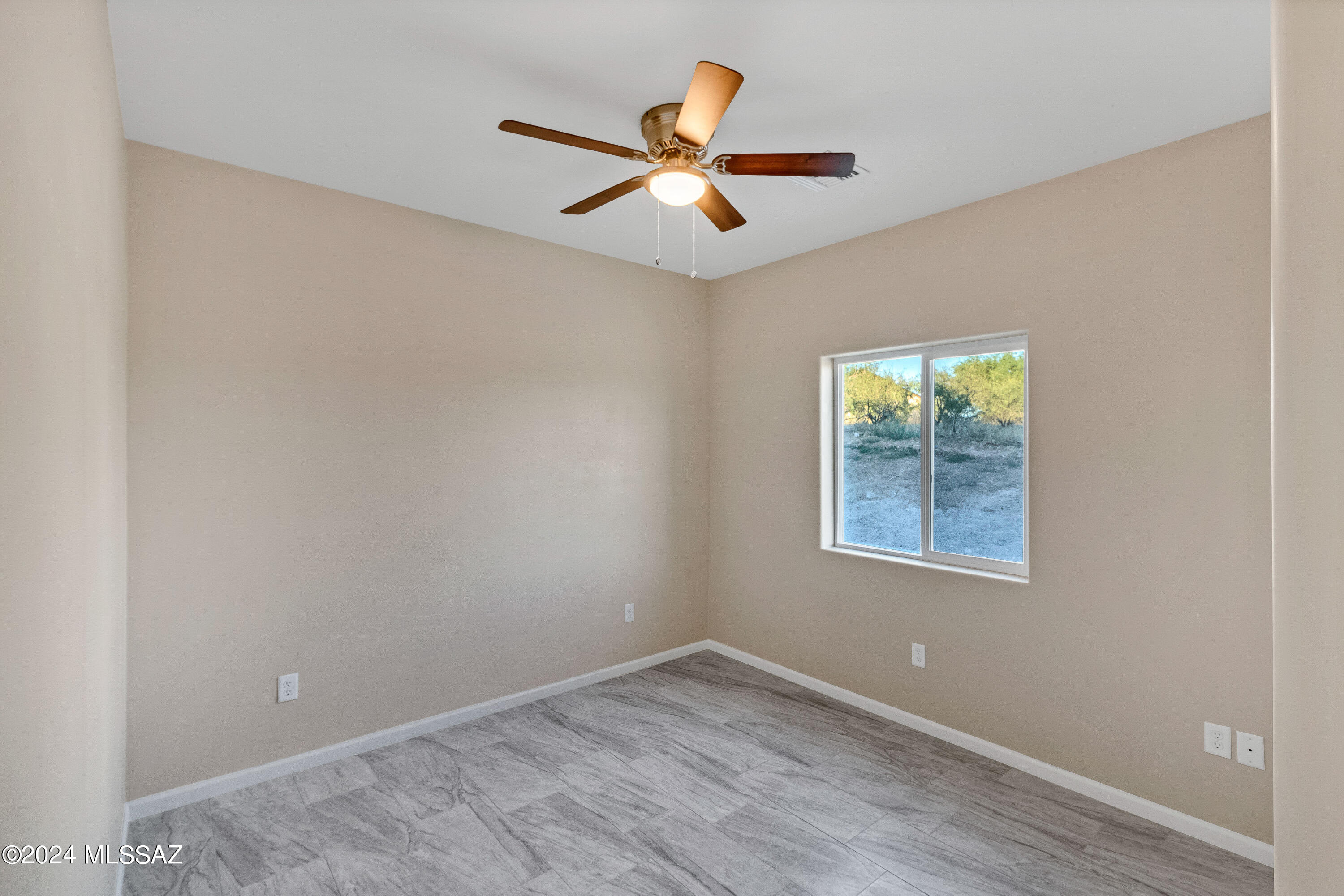 356 Globo Court Rio Rico, AZ 85648 - Photo 26 of 32 an empty room with wooden floor and windows