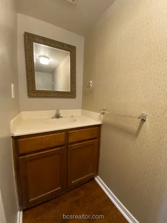 a white toilet sitting in a bathroom and a sink