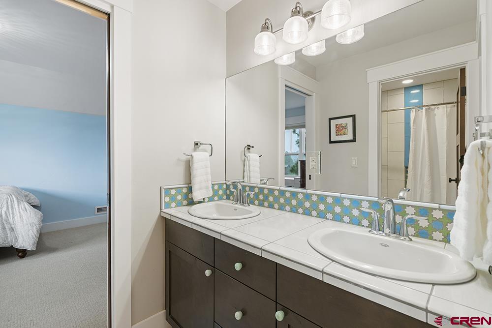 322 Window Lake Trail Durango, CO 81301 - Photo 32 of 35 a bathroom with a double vanity sink and a mirror