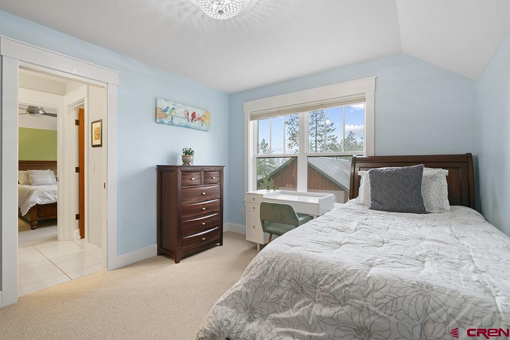322 Window Lake Trail Durango, CO 81301 - Photo 33 of 35 a bedroom with a bed and a dresser