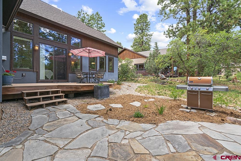 322 Window Lake Trail Durango, CO 81301 - Photo 6 of 35 a backyard of a house with barbeque oven table and chairs