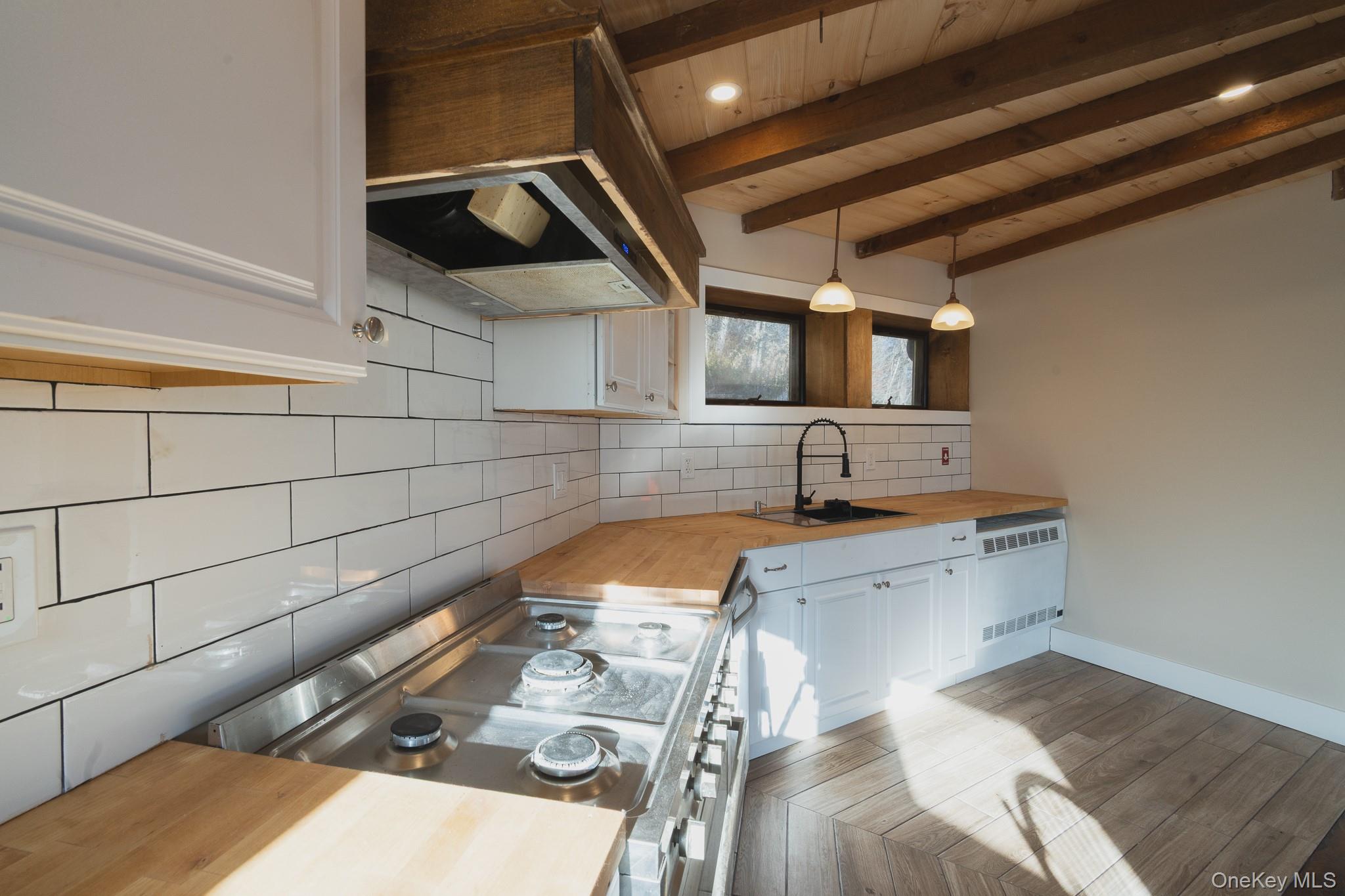 15 Deans Road Napanoch, NY 12458 - Photo 5 of 21 Kitchen featuring wood counters, white cabinetry, decorative backsplash, stainless steel range oven, and ventilation hood