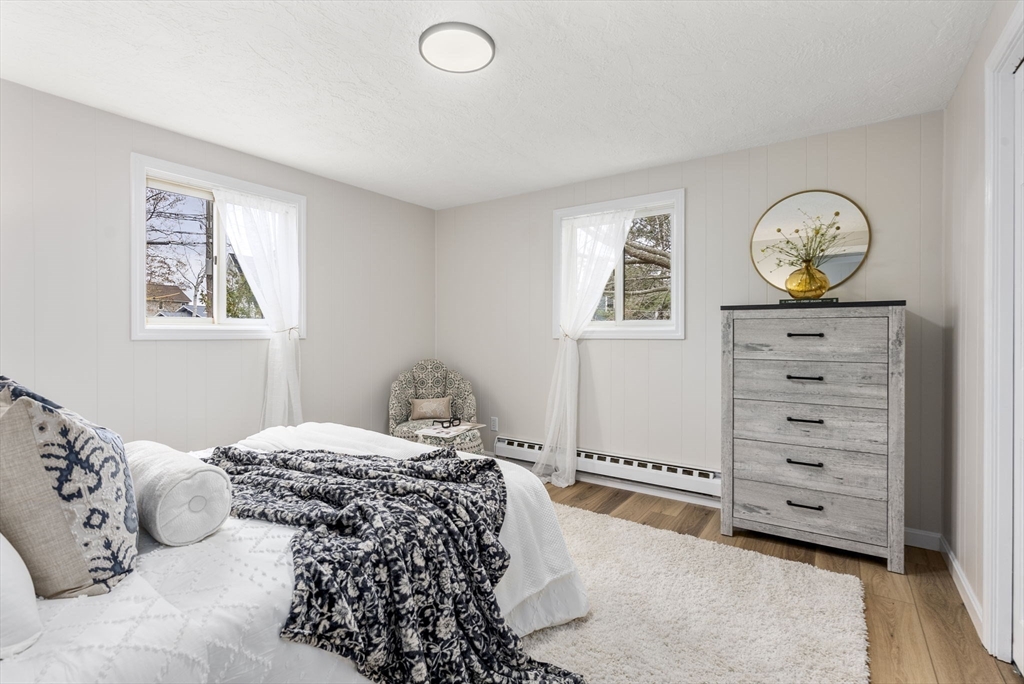 6 Henry Road Webster, MA 01570 - Photo 15 of 39 a bedroom with a bed and wooden floor